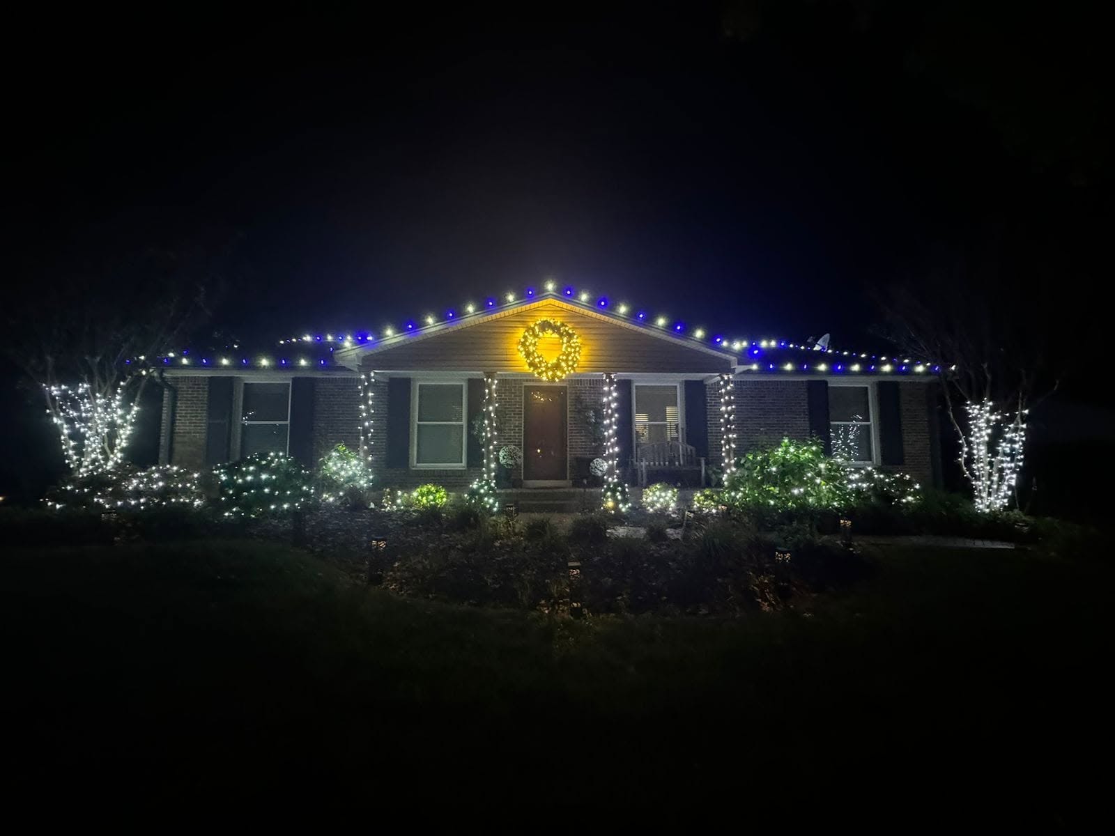 Home with multicolor roofline Christmas lights