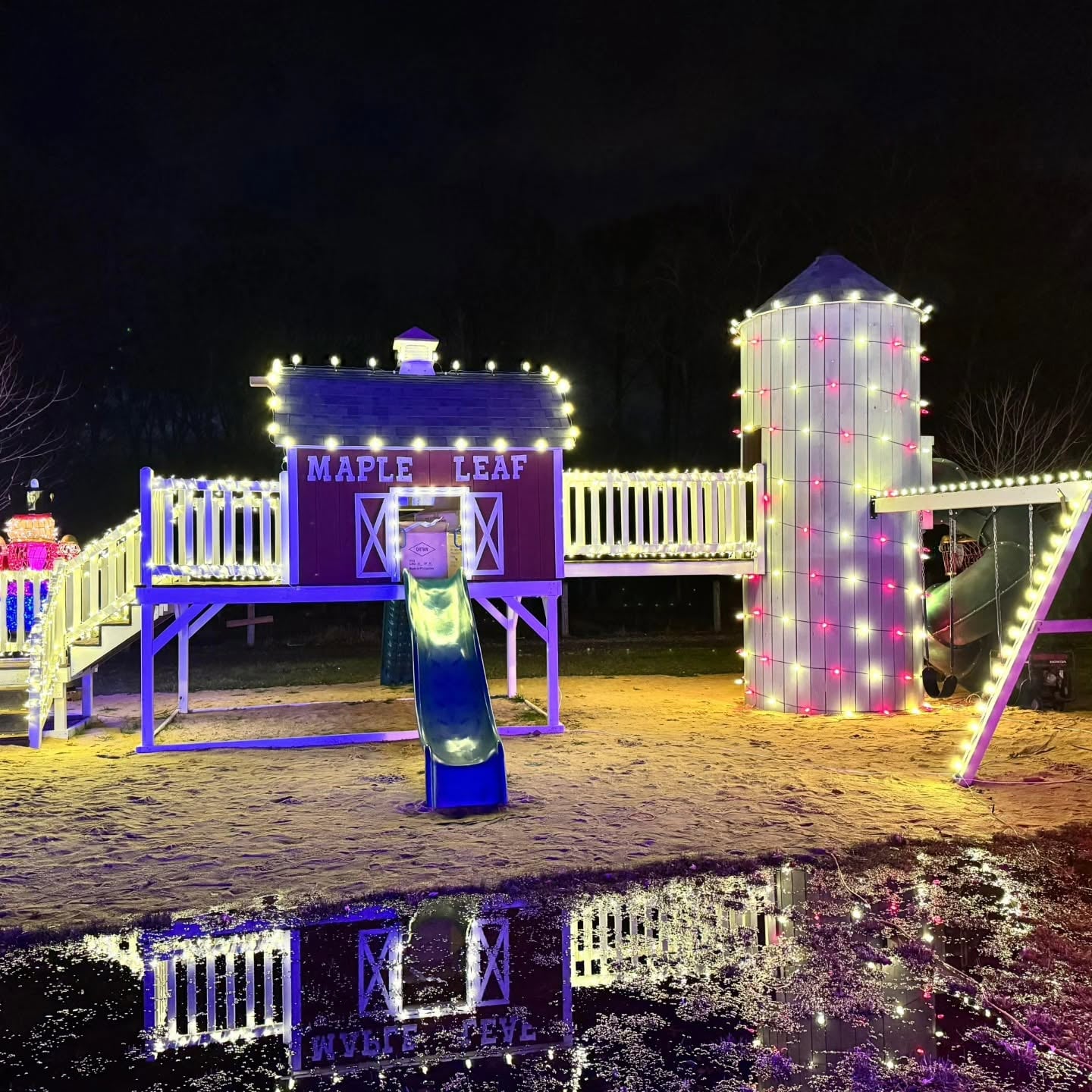 Backyard playset outlined in holiday lights