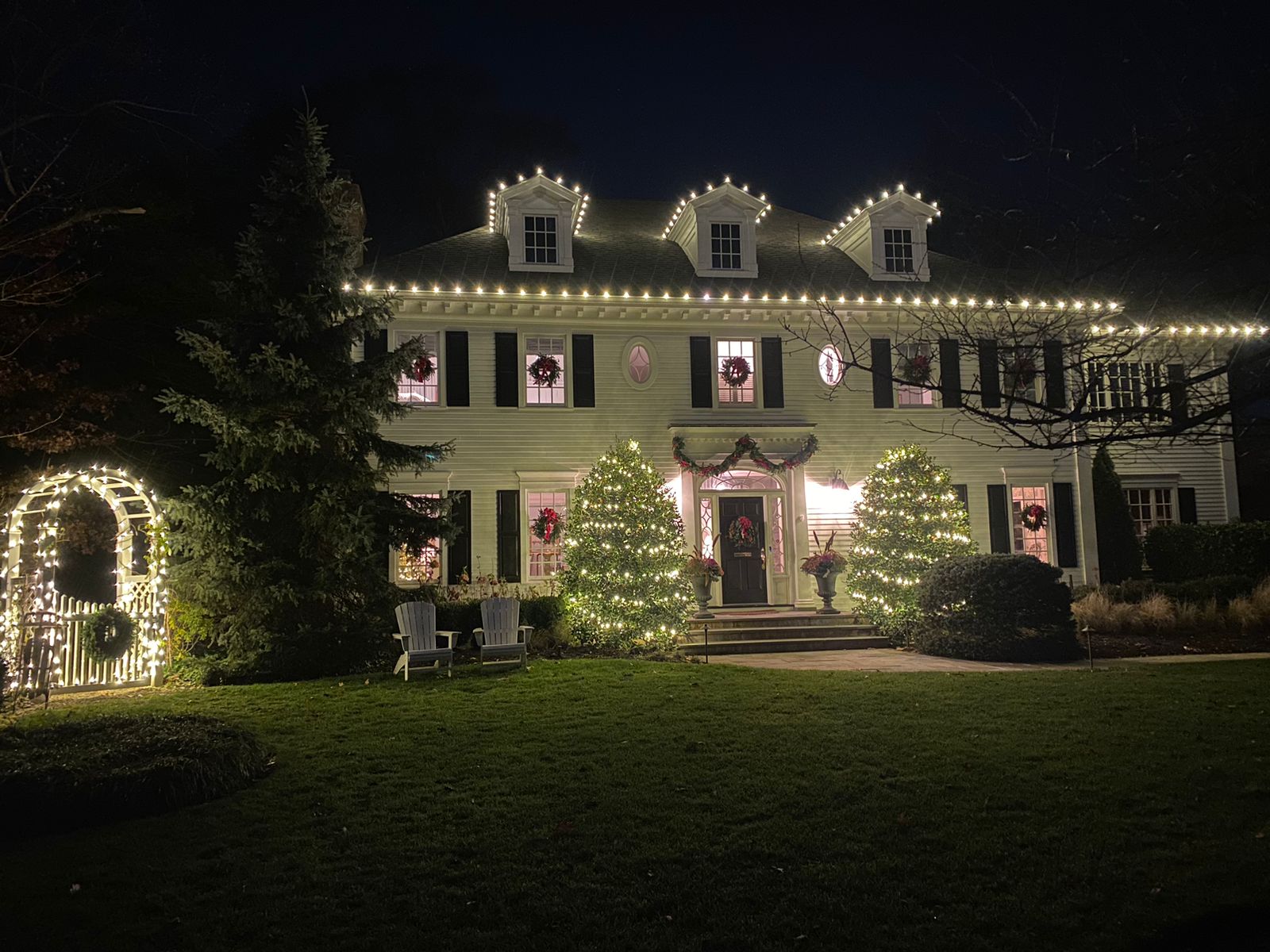 Roofline and tree LED Christmas lights installed by Midas on a New Jersey home